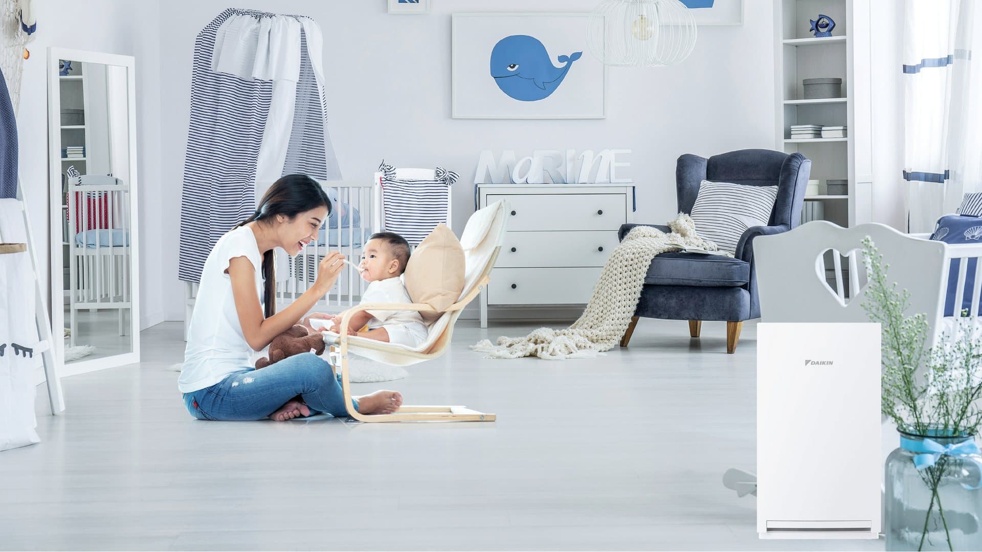 Daikin MCQ30ZVMM-H air purifier in a baby room, from Daikin's brochure.