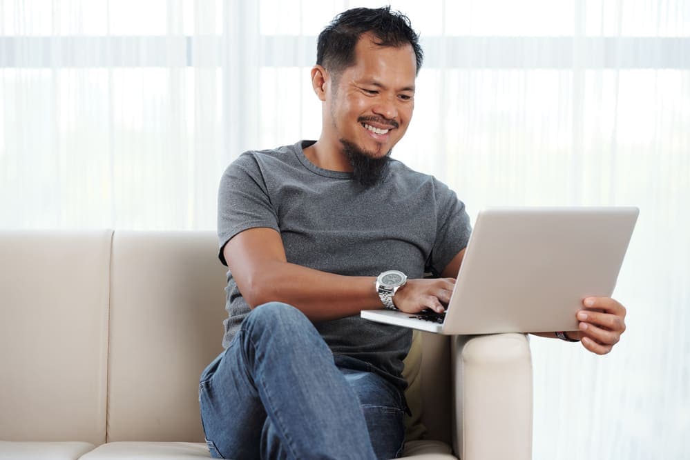 Career-driven man saving energy by minimising the aircon usage at home