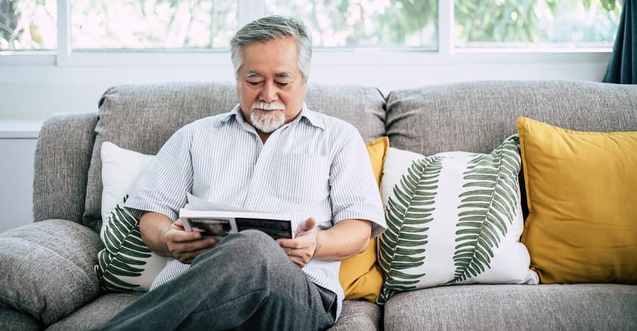 A man reviewing the installation manual for an air conditioner before beginning the setup process