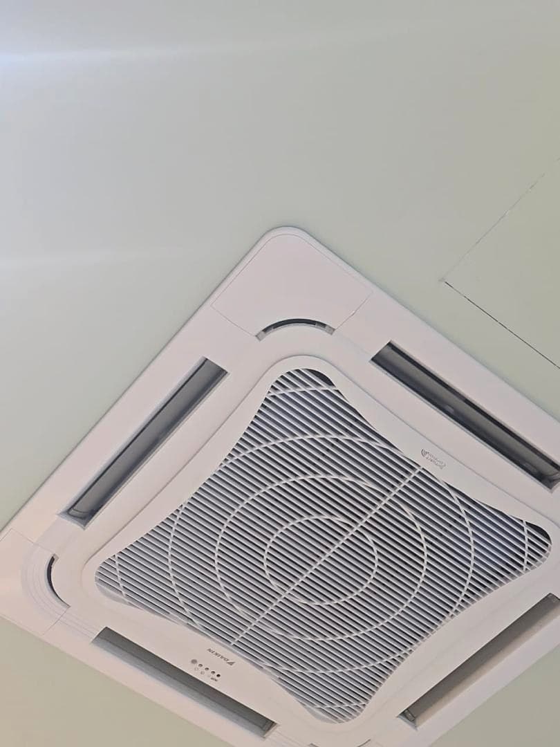 A ceiling cassette installed flush into a smooth white clinical ceiling.