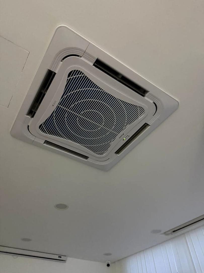 A second ceiling cassette in a different room, beside a linear ceiling diffuser.