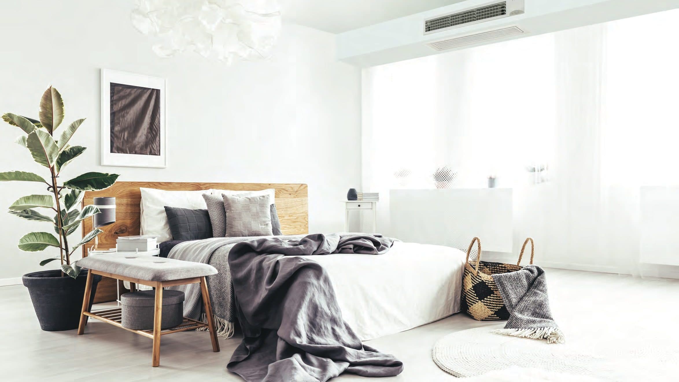 A bedroom with a ceiling unit above the window.