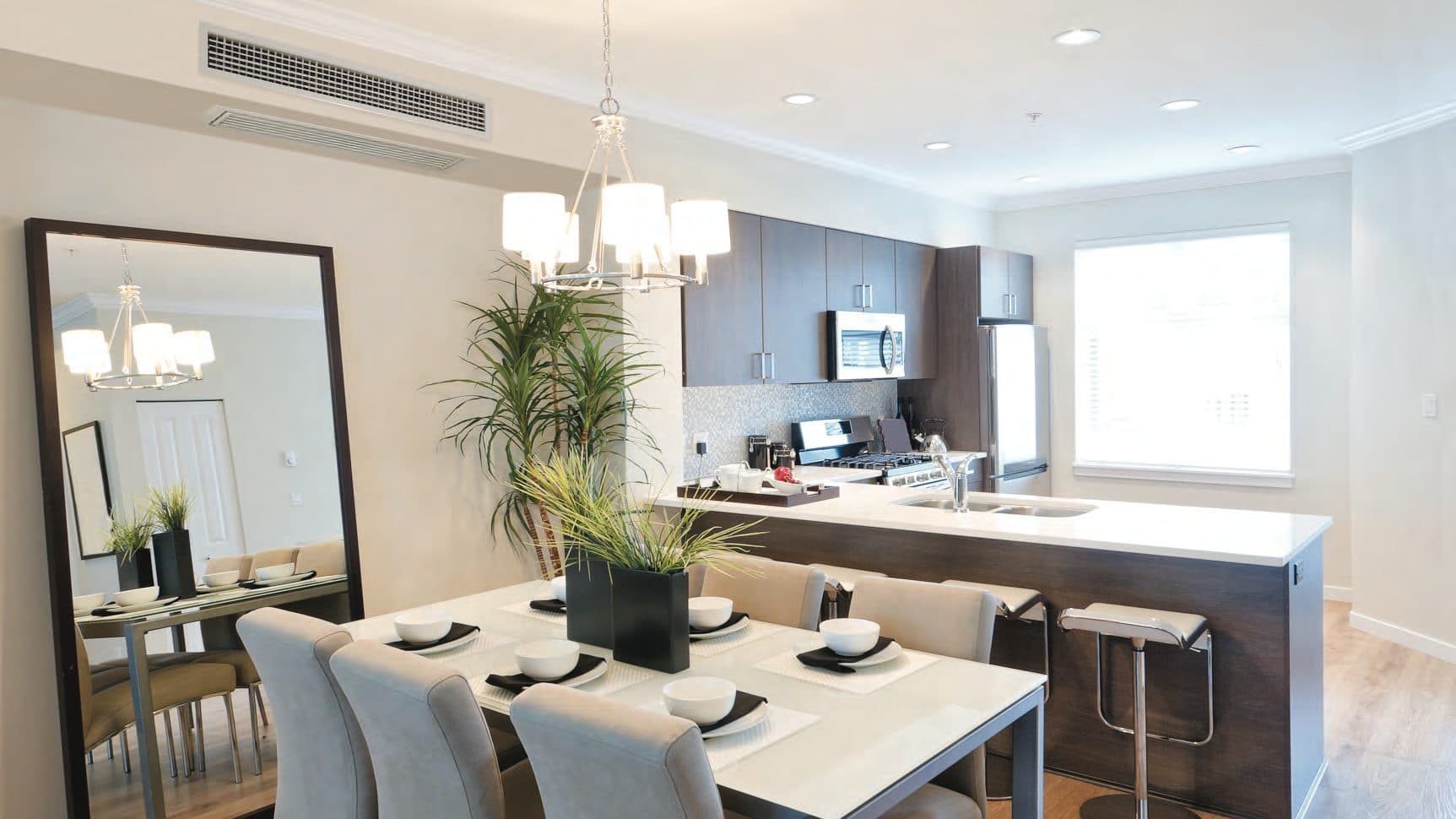 A dining room with a slim ceiling unit.