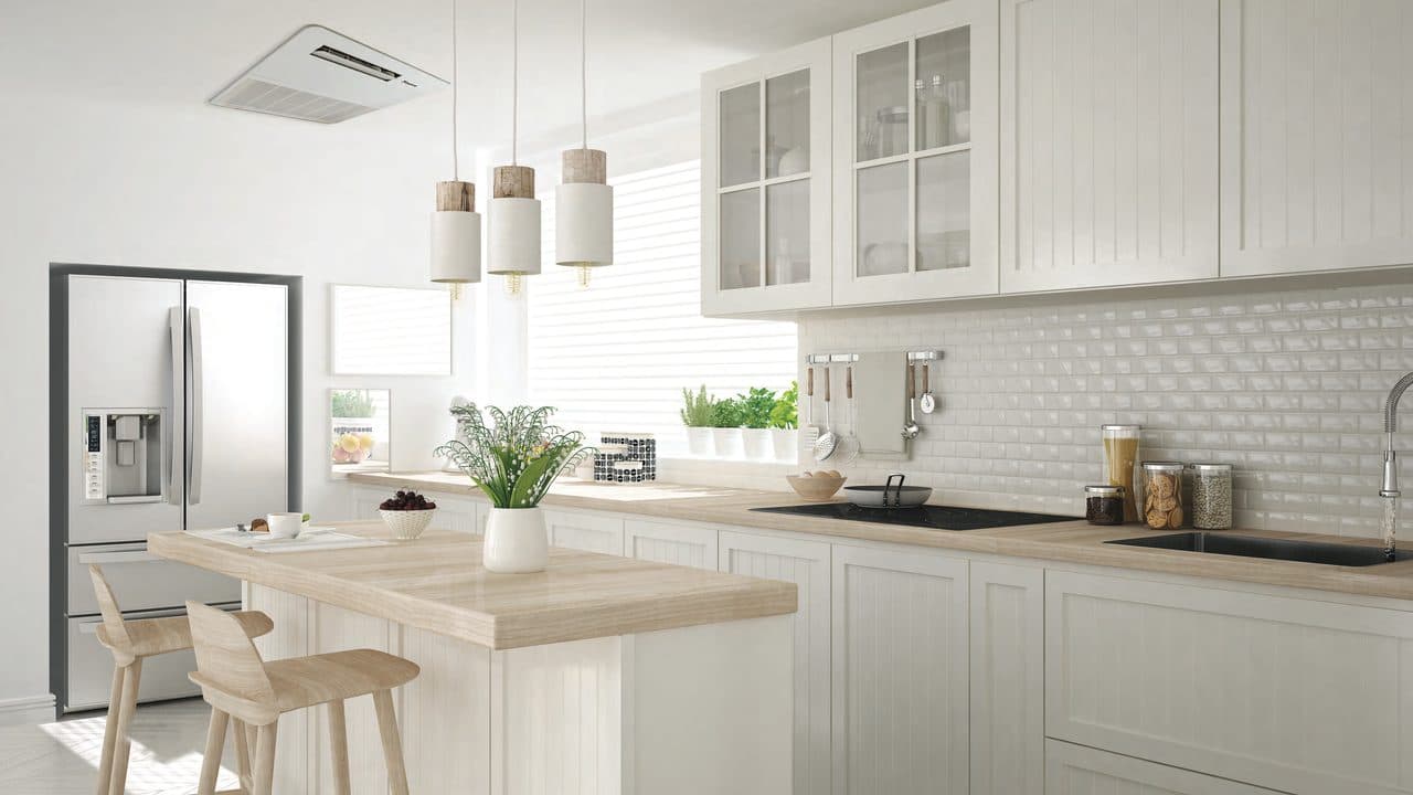 An open dry kitchen with a ceiling cassette above the island.