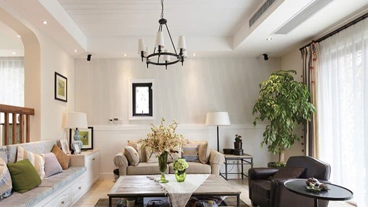 A family room with linear grilles along the ceiling bulkhead.