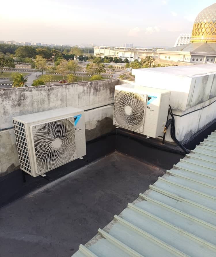Condensing units installed on a roof deck above the administrative building.