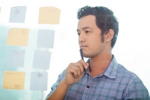 Thoughtful Young Asian Business Man Planning Work