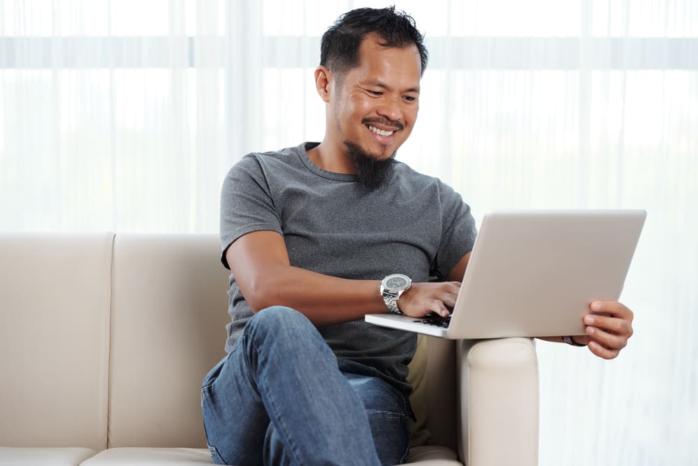 Career-driven man saving energy by minimising the aircon usage at home